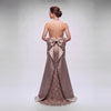 Elegant evening gown with a large bow detail on the back against a plain background