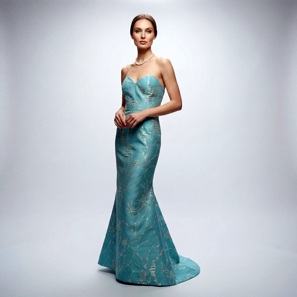 Shop our NYC-made Aqua Blue Brocade Trumpet Gown. Strapless sweetheart neckline with metallic silver floral embroidery. Available for special order in custom colors.