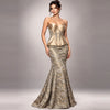 A woman models a strapless sweetheart mermaid gown in metallic gold and beige patterned fabric against a neutral gray studio background.