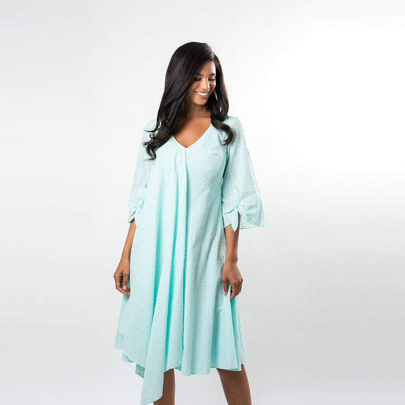 A draped overlay gives this fabulous piece a boho feeling while allowing you to show off your figure in a subtle way, extruding femininity. Made from a beautiful and airy cotton baby clip dot, this dress lends itfelf for many summer and spring affairs.